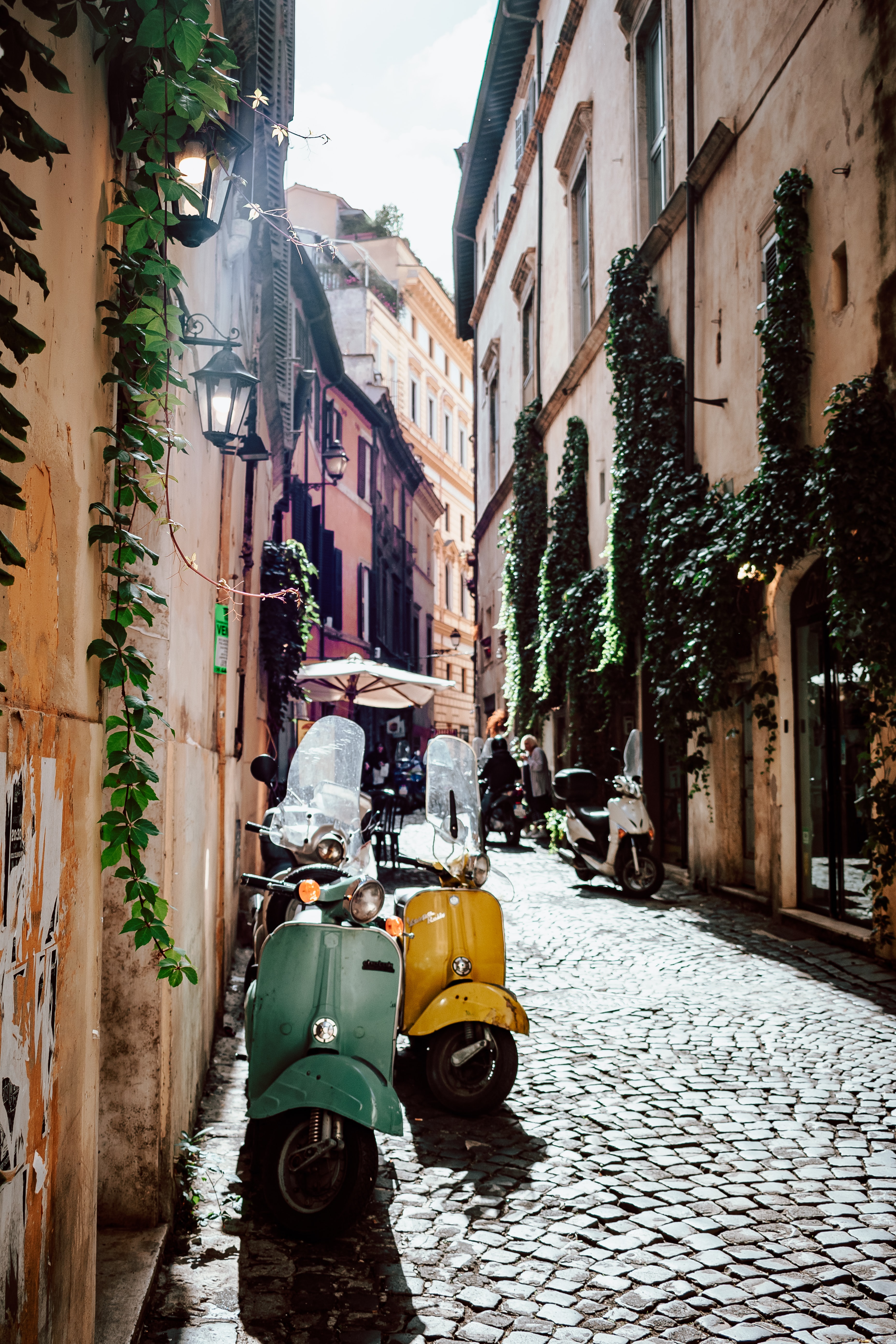 two vespas on a street in Rome